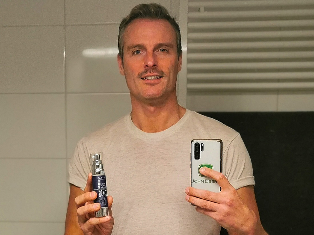 Man holding Particle Face Cream bottle
