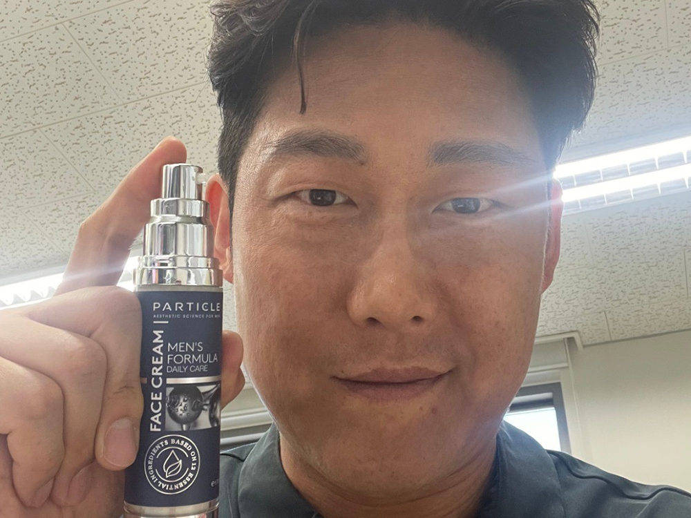 Asian man holding Particle Face Cream