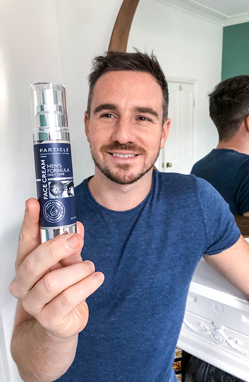 Young man holding Particle Face Cream