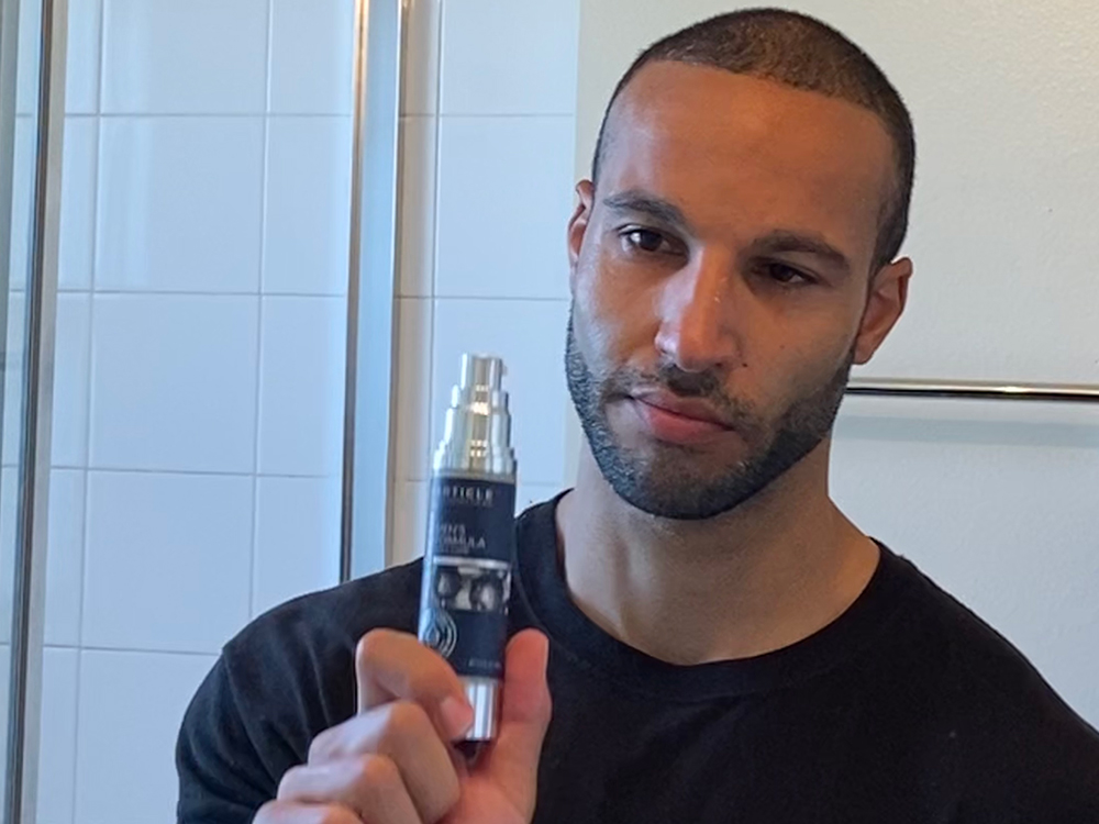 Man holding Particle Face Cream bottle