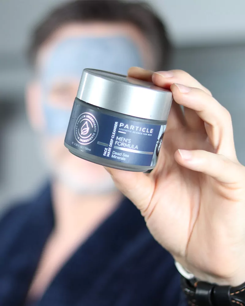 Close-up of Particle For Men face mask showing product details and branding.